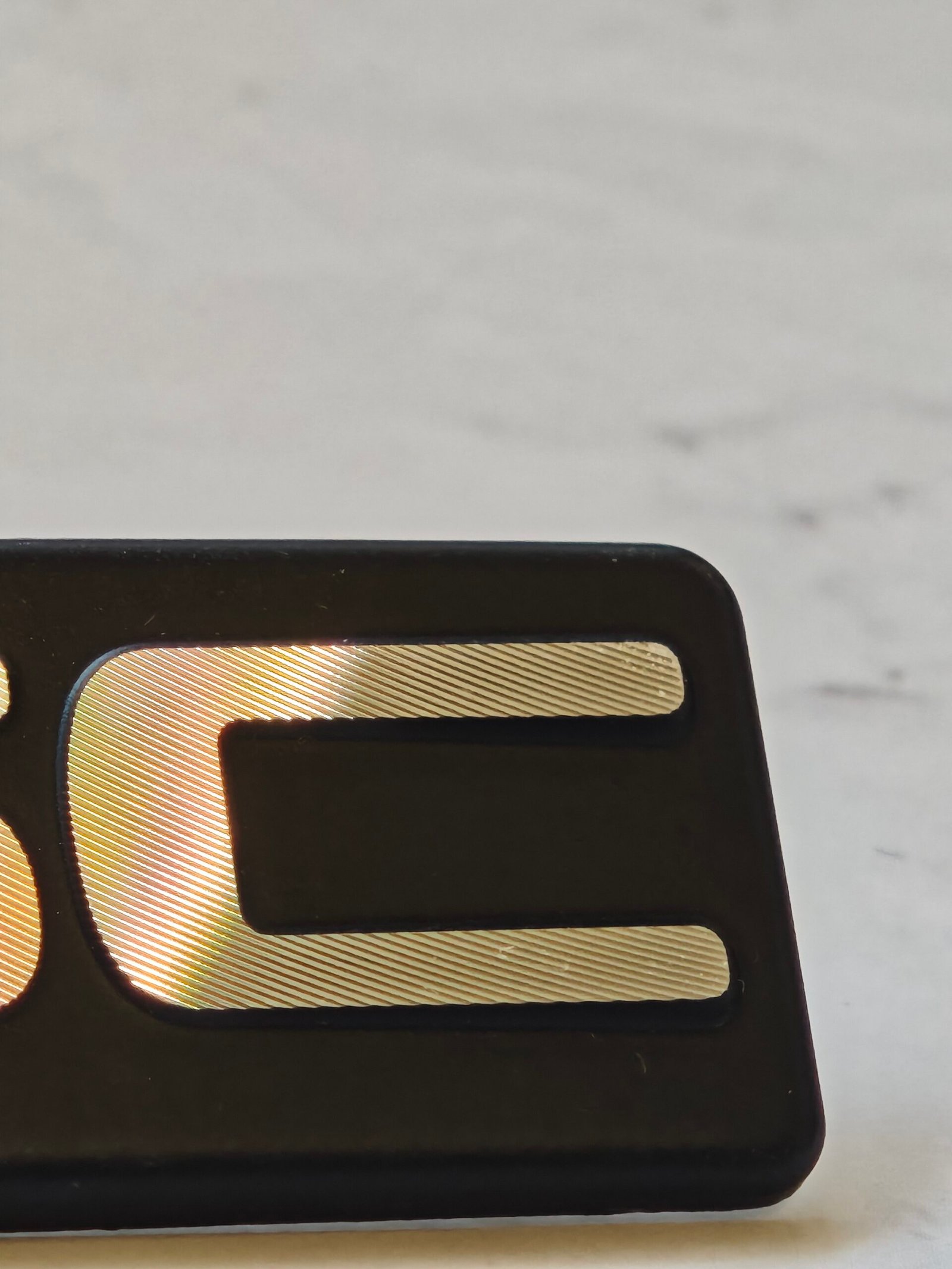 Close-up of precision diamond cut texture on aluminum metal badge